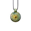 A spherical handcrafted glass pendant necklace showcasing detailed green and gold flower petals spiraling inward toward a brilliant, floating embedded opal gemstone.
